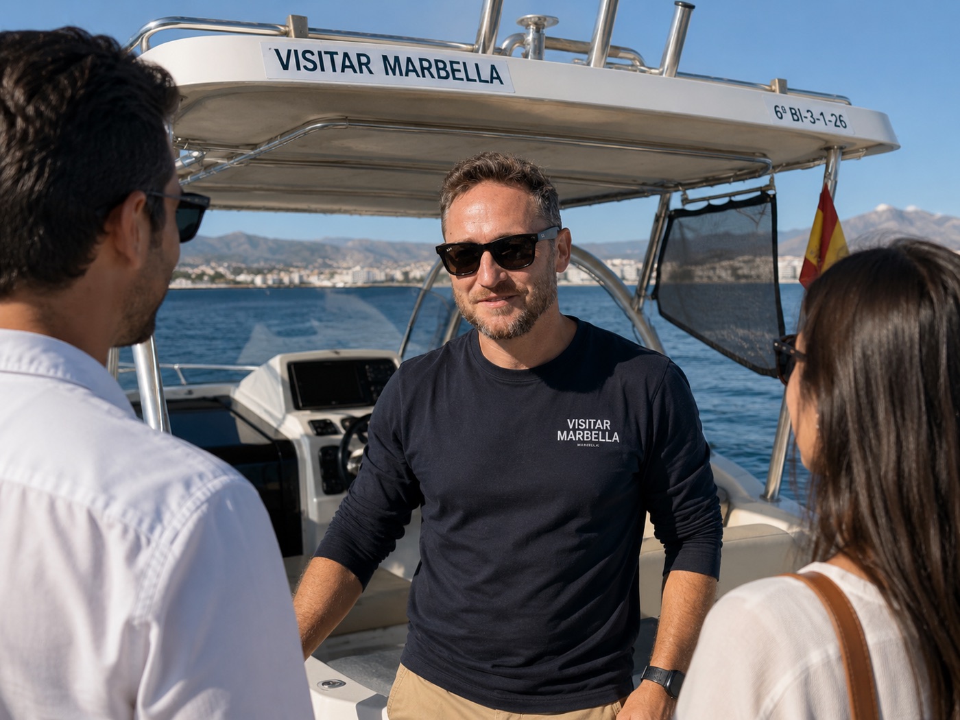 Jason, the Visitar Marbella skipper, talking with guests aboard the Beneteau Flyer 9 off the Marbella coast